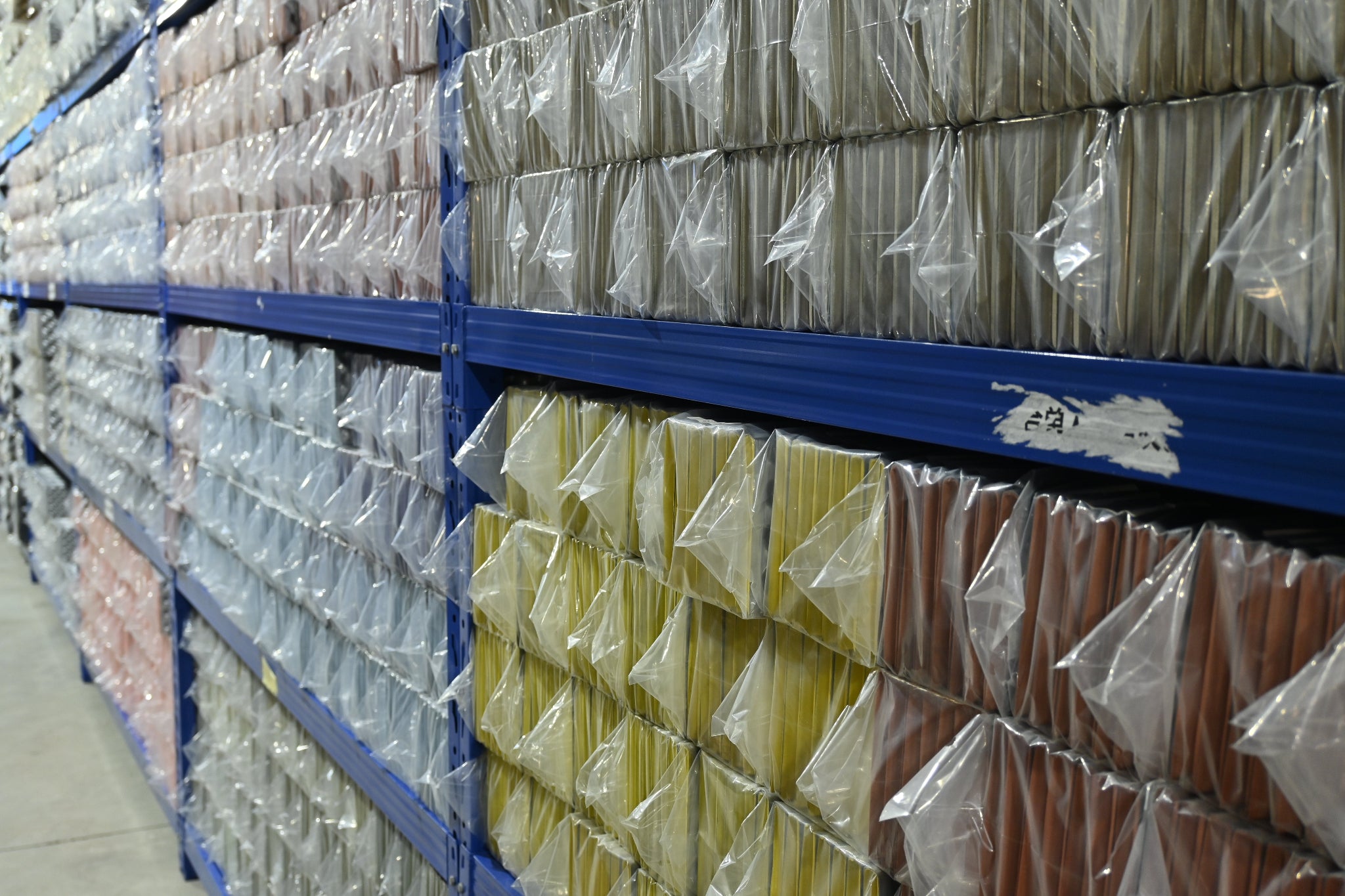 The shelves in the factory were neatly lined with packaged foam pads.